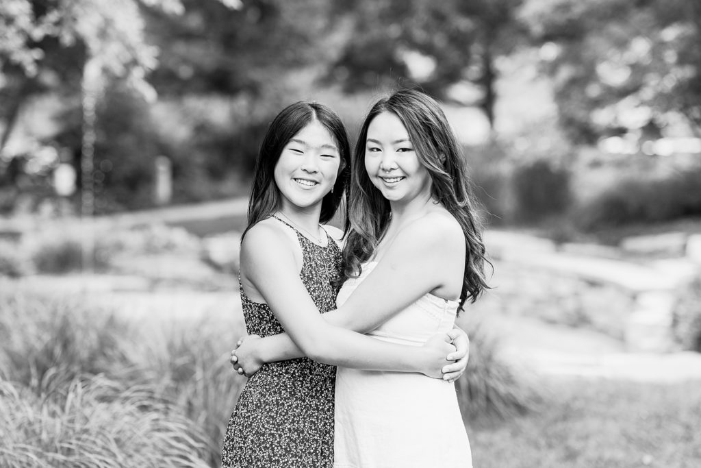 sisters smiling for family photos at leslie tassel park